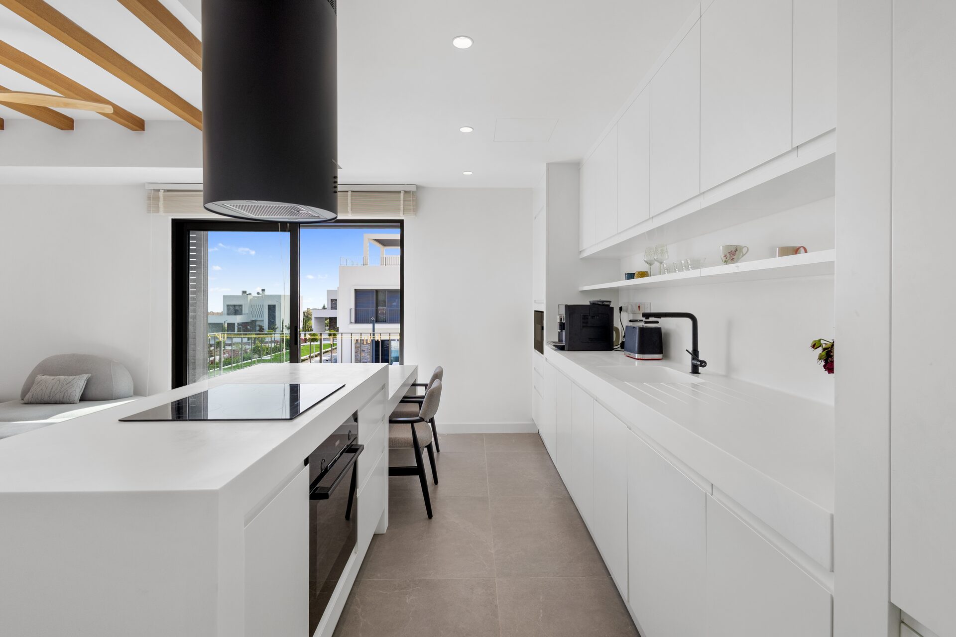 Galley kitchen with white cabinetry